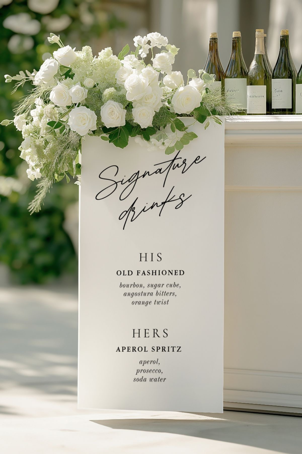 Floral styled signature drinks bar with champagne bottles