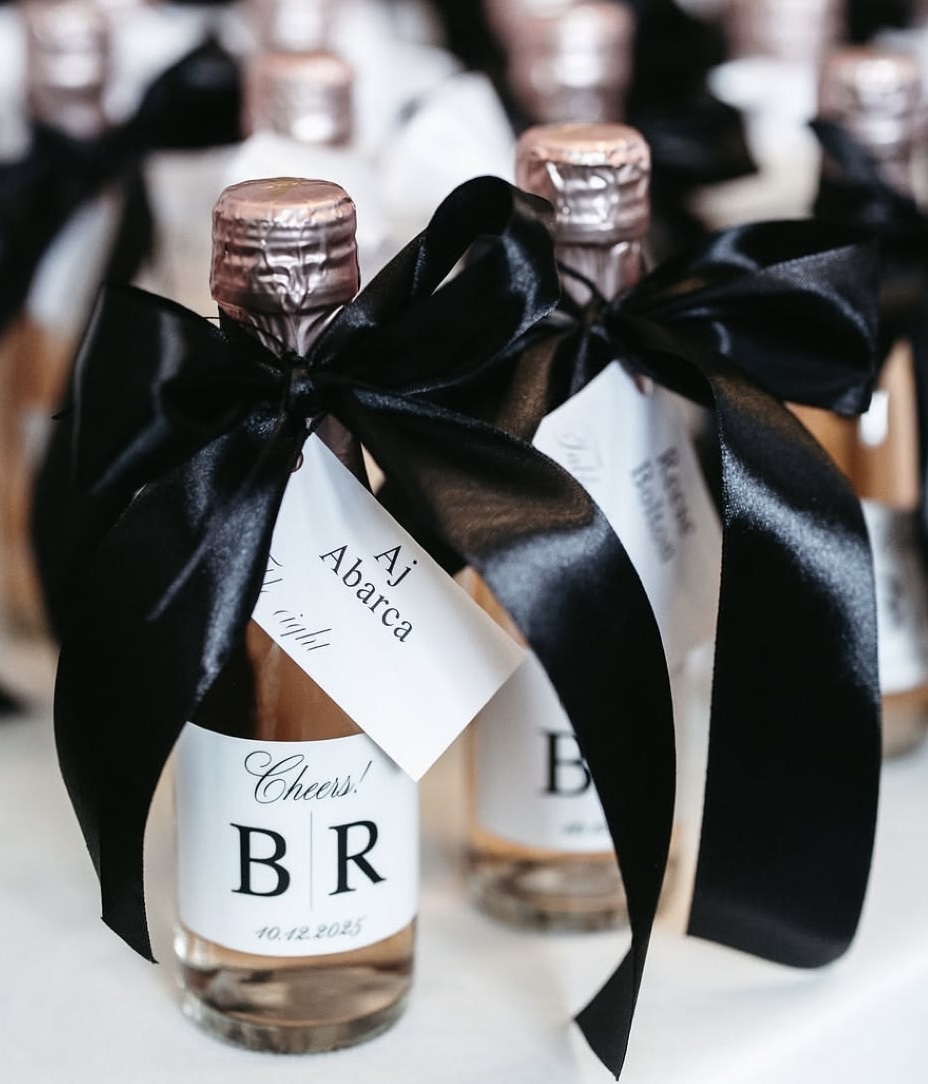 Mini prosecco bottles with black satin bows and personalized favor tags